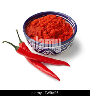 Bowl with red Moroccan harissa and fresh red chili peppers on white background Stock Photo