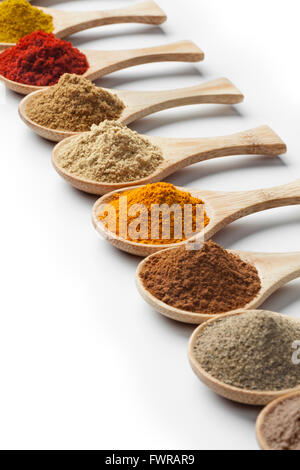 Variety of dried herbs and spices on wooden spoons Stock Photo