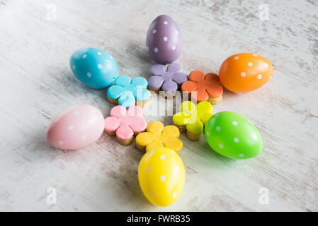 Colorful easter eggs with flower cut fondant covered homemade cookies Stock Photo