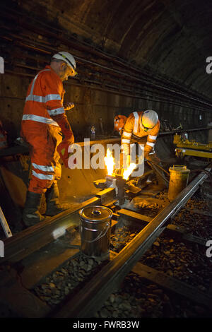 Engineers weld replacement track components together using thermite ...