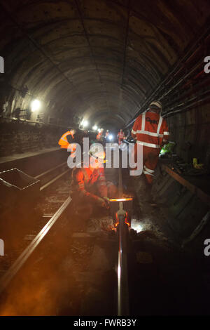 Engineers weld replacement track components together using thermite ...