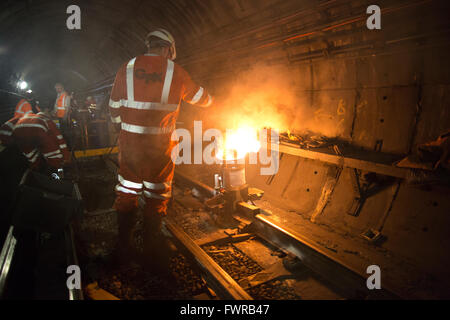 Engineers weld replacement track components together using thermite ...