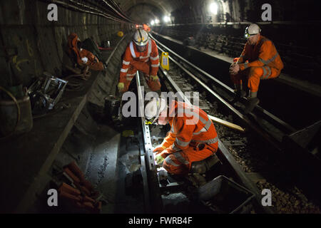 Engineers prepare replacement track components before using thermite welding on London Underground rail track, London, UK Stock Photo