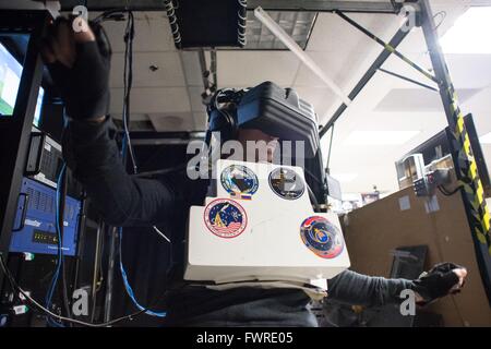 International Space Station Expedition 48/49 crew member astronaut Kate Rubins wearing a VR headset during robotics and spacewalk training in the Virtual Reality Lab at the Johnson Space Center January 13, 2016 in Houston, Texas. Stock Photo