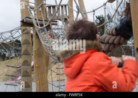 Wooden play adventure park with child playing Stock Photo