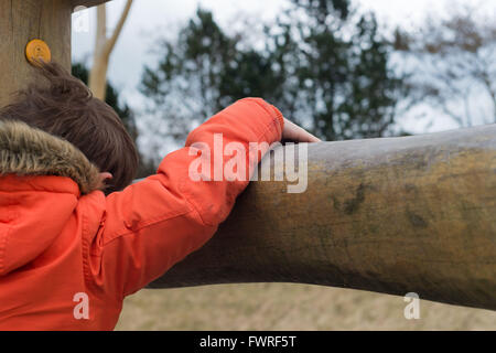 Wooden play adventure park with child playing Stock Photo