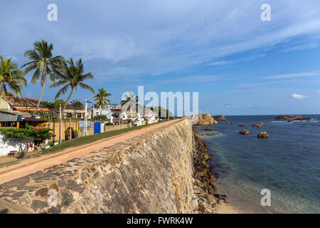 Galle Fort, listed as World heritage by UNESCO, old colonial houses behind the sea side walls of the fortified town, Sri Lanka Stock Photo