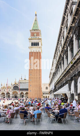 Tourists seated outside of Caffe Florian in St Mark's Square, San Marco, Venice, Italy Stock Photo