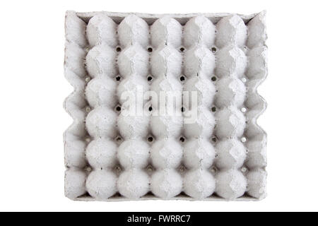 Empty egg panel on isolated white background with clipping paths. And eggs in the same light conditions in uniform. To be arrang Stock Photo