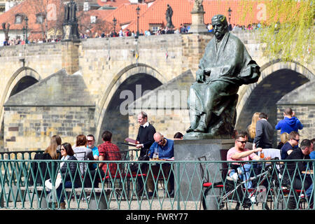 Prague, Czech Republic. Terrace of Club Lavka cafe overlooking the Vltava River. Statue of Bedrich Smetana in front of the Smeta Stock Photo