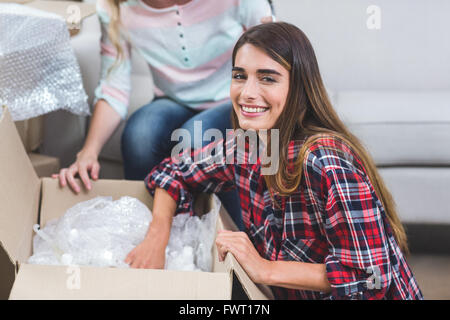 Woman unpacking carton boxes Stock Photo