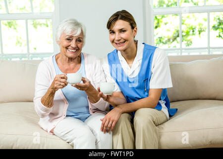 Portrait of smiling nurse with senior woman