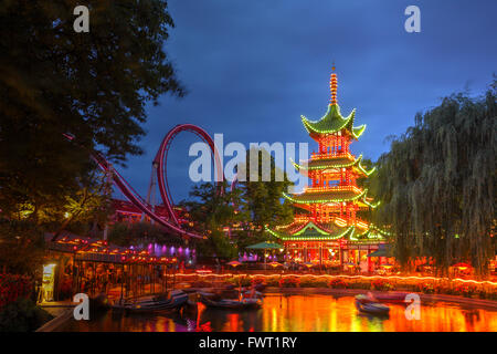 Dragon Boat lake and Dæmonen roller coaster in the background at Tivoli gardens, Copenhagen, Denmark Stock Photo