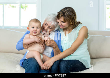 Grandmother and mother playing with cute baby boy Stock Photo