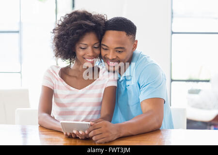 Happy couple using mobile phone Stock Photo