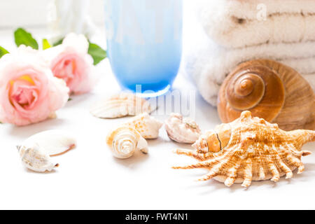 Folded towels on bathroom counter with flowers Stock Photo