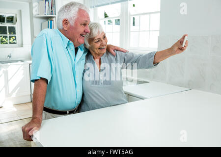 Happy senior couple taking selfie at home Stock Photo