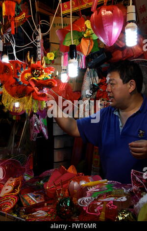 A man selling lanterns as part of the Mid-Autumn Lantern Festival in Hong Kong Stock Photo