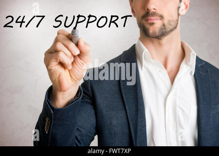 Man drawing 24/7 support on glass, isolated in grey Stock Photo