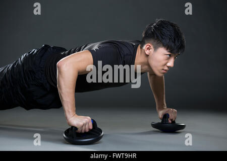 Young man doing push-ups Stock Photo