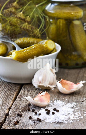 Ingredients for pickling cucumbers : garlic, black pepper, salt, dill on a wooden background Stock Photo