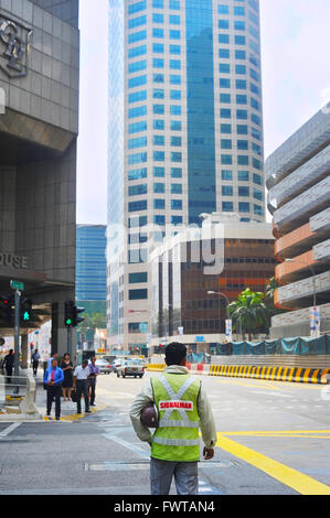 Worker crossing the street in Downtown of Singapore. Stock Photo