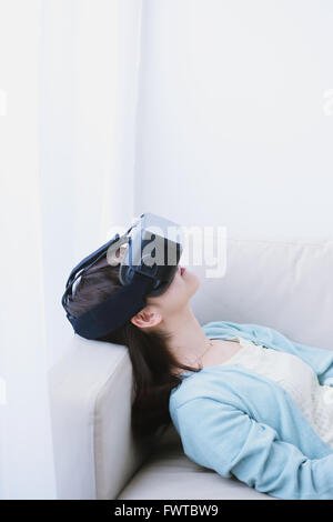 Japanese woman using virtual reality device Stock Photo