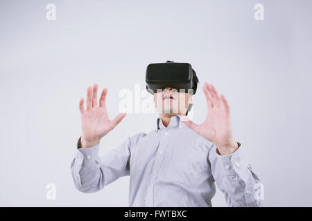 Japanese man using virtual reality device Stock Photo