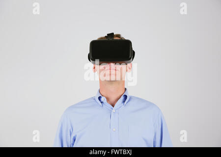 Caucasian man using virtual reality device Stock Photo