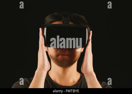 Japanese man using virtual reality device Stock Photo