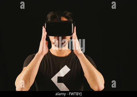Japanese man using virtual reality device Stock Photo