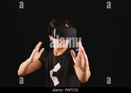 Japanese man using virtual reality device Stock Photo