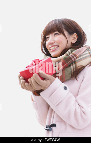 Attractive Japanese woman with gift on a Winter day Stock Photo