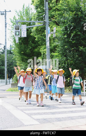 Japanese school kids crossing street Stock Photo