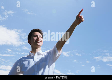 Portrait of young Japanese man by the sea Stock Photo