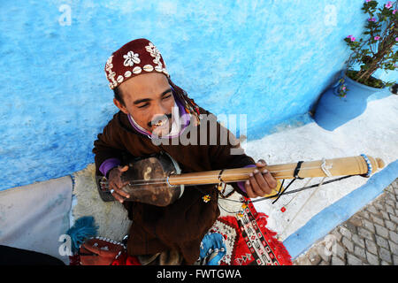 A Gnawa musician playing the Sintir in the kasbah or Rabat. Stock Photo