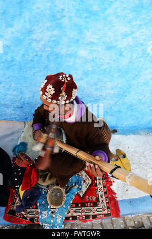 A Gnawa musician playing the Sintir in the kasbah or Rabat. Stock Photo