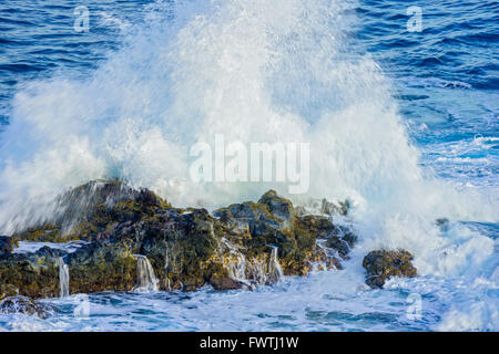 waves crashing on rocks in Poelua Bay, Maui Stock Photo