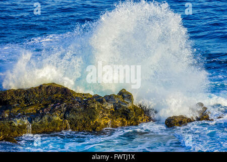 waves crashing on rocks in Poelua Bay, Maui Stock Photo