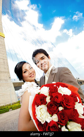 couples of happiness and romantic Bride and groom with beautiful rose bouquet Stock Photo