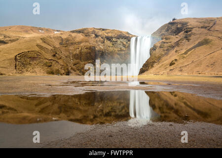 skogafoss waterfall and its reflection on the South of Iceland near the town Skogar Stock Photo