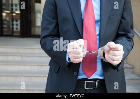 Businessman in handcuffs Stock Photo