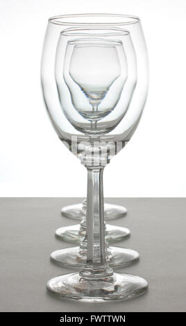 Four wine glasses lined up in a row. Stock Photo