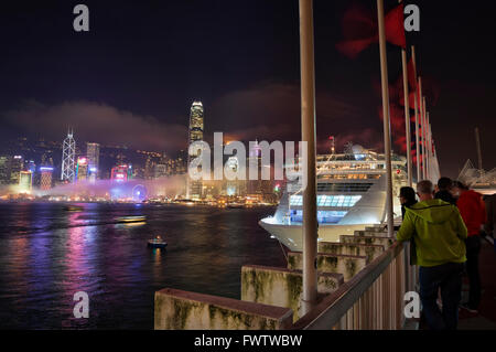 Tourists watching the famous Hong Kong city skyline, Victoria harbor, Hong Kong, China. Stock Photo