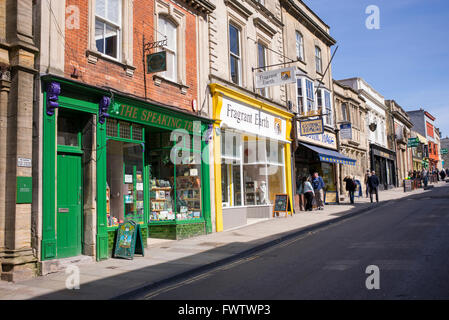 Colourful shop fronts in the high street. Glastonbury, Somerset, England Stock Photo