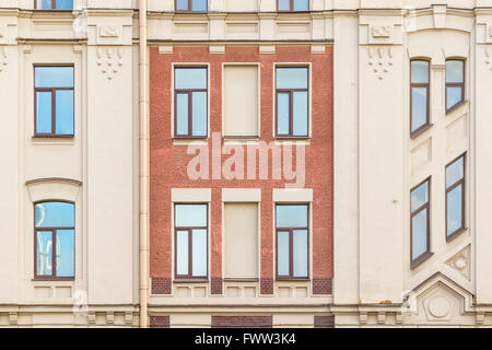 Several windows in row on facade of urban apartment building front view, St. Petersburg, Russia Stock Photo