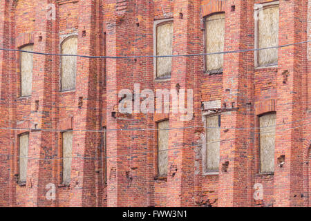 Several windows in row on brick facade of industrial building angle view, St. Petersburg, Russia Stock Photo