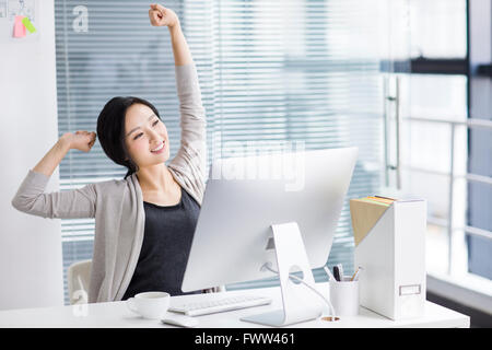 Young woman relaxing in office Stock Photo