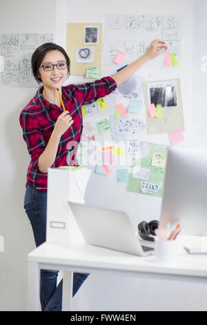 Female designer working in office Stock Photo