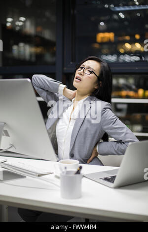 Businesswoman working late in office Stock Photo
